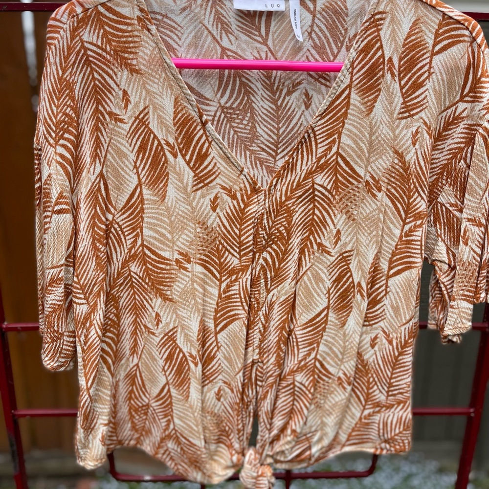 Brown, tan and cream colored blouse.